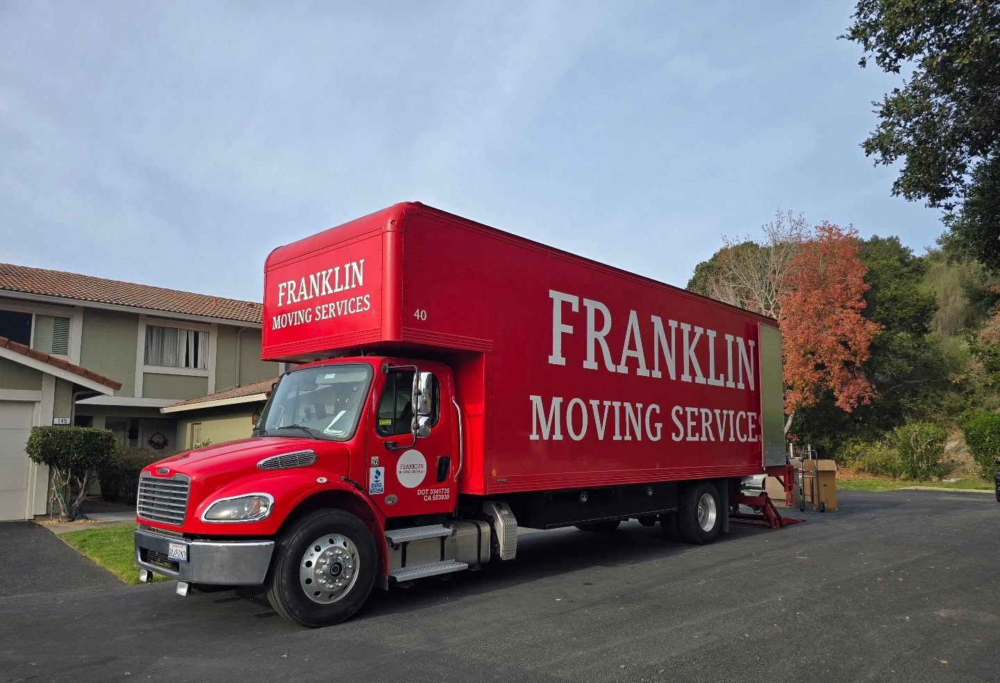 Red Franklin Moving Service truck parked outside.